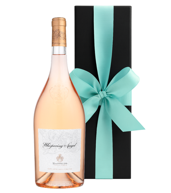 Bottle of Whispering Angel rosé wine with a turquoise ribbon on a black box against a white background